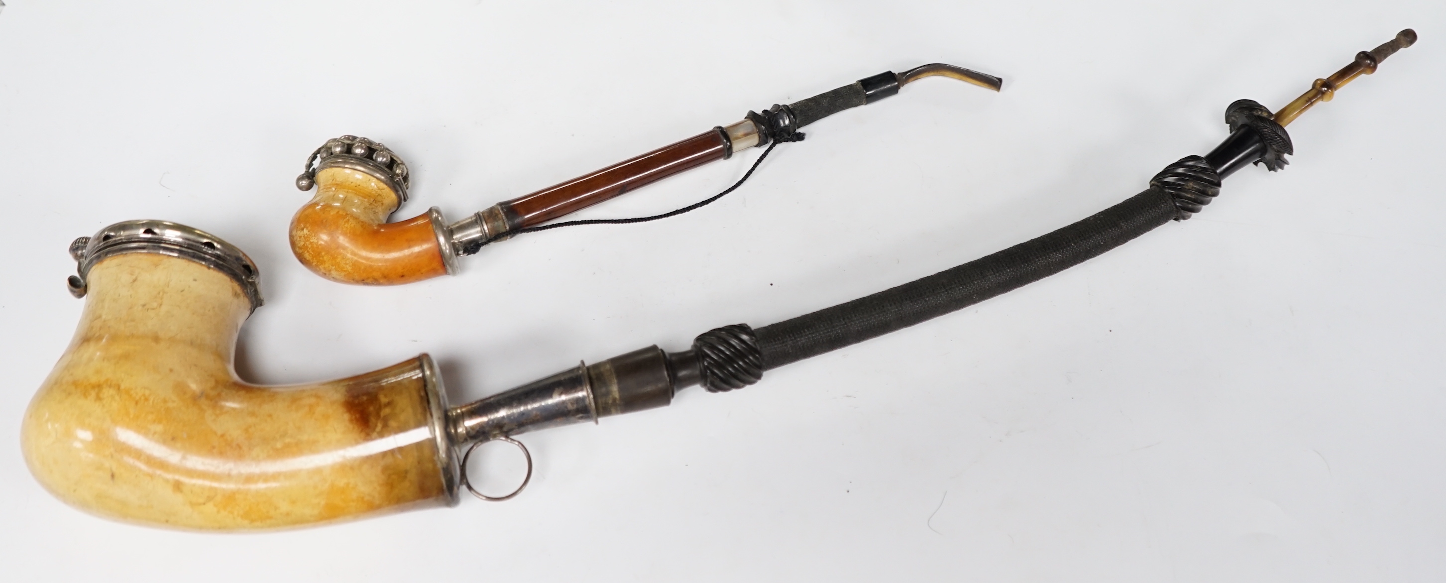 Ten mixed novelty pipes in various sizes with various mixed bowls, together with a small collection of mostly amber mouthpieces and other smoking related items, largest pipe 61cm long